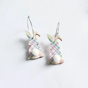 Close-up of Easter bunny earrings with plaid pattern and white fluffy pompom tail
