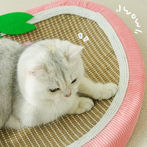 Peach shaped sisal cat scratcher lounge with pink corduroy trim and a white cat resting