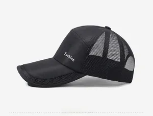 Detailed side view of breathable black mesh trucker hat with white Fashion print text