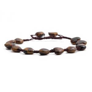 Detailed view of heart-shaped tiger eye stone and handmade braided rope bracelet
