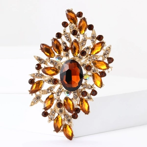 Macro shot of gold vintage brooch with amber crystals and marquise-cut rhinestones