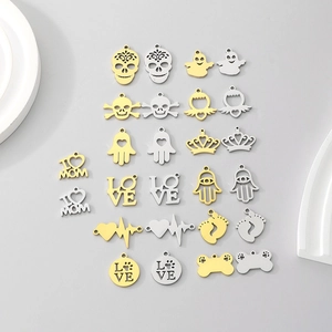 Assorted DIY stainless steel pendants in gold and silver with skull and heart motifs