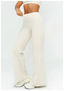Detail of high waisted flared yoga pants featuring contrast stitching in off-white fabric