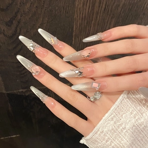 Handmade cat-eye press-on nails with 3D crystal bows, pearls, and pink gemstones