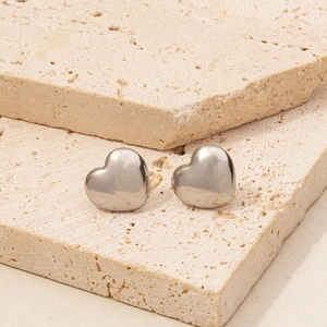 Close-up of heart-shaped 304 stainless steel stud earrings on decorative stone