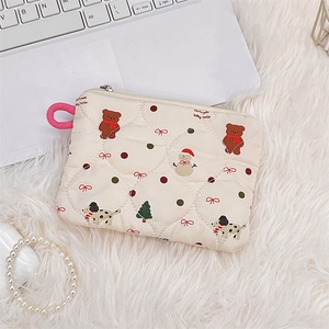 Close-up of beige quilted Christmas pouch with cartoon bear and snowman patterns