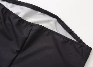 Close-up of the elastic waist detail and stitching on this black avocado print dress