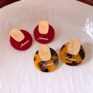 Retro round acetate earrings in deep red and tortoiseshell with gold metal accents