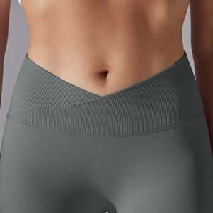 Close-up of high-waist V-shaped crossover waistband on grey ribbed seamless yoga pants