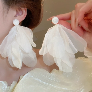 Floral earrings with white fabric petal tassels worn by model for an elegant look