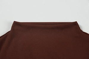 Detail of mock neck collar on dark brown knitted dress showing fine stitching and fabric texture