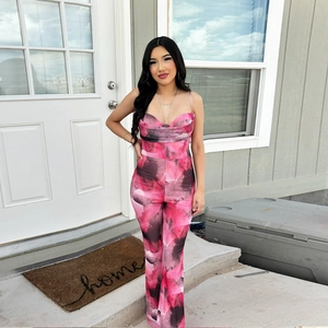 Detail of pink and black abstract print mesh jumpsuit with slim fit and halter neck