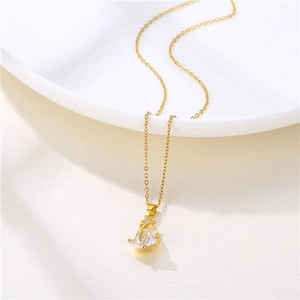 Golden stainless steel tulip necklace with clear zircon pendant on a white background