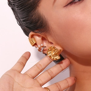 Close-up of 18K gold-plated irregular hammered texture ear cuff with pearl detail