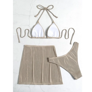 Three-piece beige ribbed bikini set featuring halter top, bottom, and ruched mini skirt