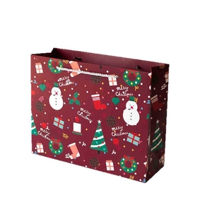 Deep red Christmas paper gift bag with snowman and tree patterns for holiday wrapping