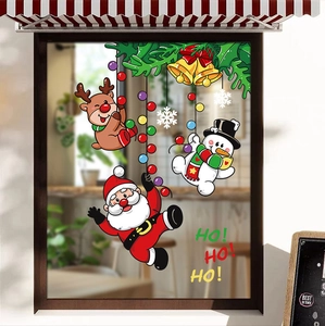 Christmas window stickers featuring Santa, reindeer, and snowman in a cozy cafe setting