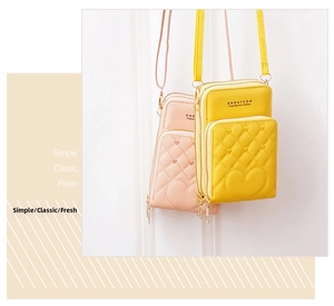 Detail of multi-layer zipper crossbody bags with quilted heart pattern and slim straps
