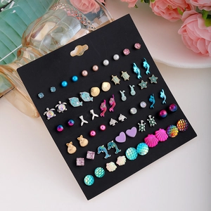 Ocean themed stud earrings set featuring dolphins starfish shells and pearls on black card