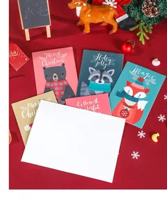 Flat lay of colorful Christmas cards with cartoon animals on a red festive background