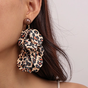 Close-up of leopard print fabric petal earrings on a model for a vintage look