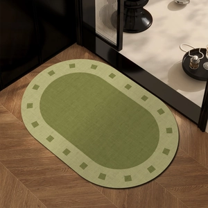 French style oval absorbent bathroom mat in dark green with geometric border design