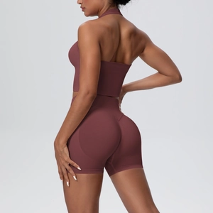 Detail of a dark mahogany two-piece seamless yoga set with halter top and lifting shorts