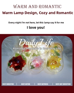 Detail of red pink and yellow roses in glass dome with warm LED lights and wooden base