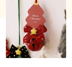 Close-up of red metal bell and velvet bow ornament on a Christmas tree decorative card