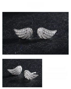 Macro view of S925 silver angel wing earrings with sparkling cubic zirconia pavé