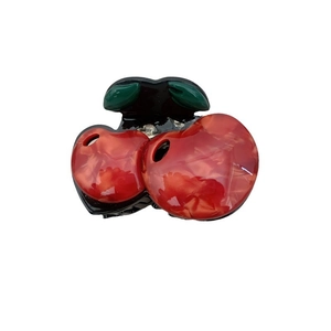 Creative cherry-shaped acetate hair claw clip with red fruit and green leaves on white background