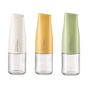 Three automatic gravity-lid glass oil dispensers in white, yellow, and green colors