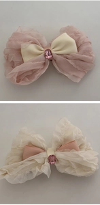 Detail of ballet style tulle bow hair clip with a pink rectangular gemstone centerpiece