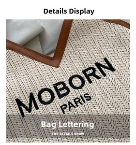 Detailed view of MOBORN PARIS embroidery on beige woven straw and brown leather bag