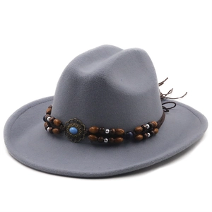 Detailed shot of grey wool fedora hat with bohemian braided band and turquoise bead