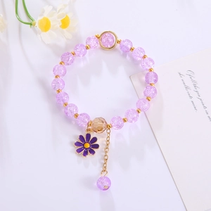 Handmade daisy floral bracelet with purple cracked crystal beads and gold pendant