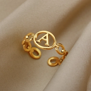 Detail of 18k gold plated chain ring featuring an engraved hollow letter A design