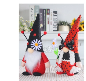 Detail of ladybug gnome couple plush with white beard and braids for home decor
