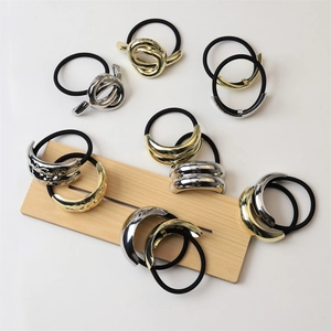 Detailed view of high-quality gold and silver alloy metallic knot elastic hair ties