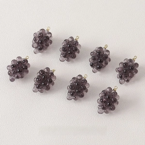 Detailed view of eight purple resin grape charms with gold loops for DIY jewelry making
