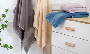 Detailed view of plush cotton towels in grey, yellow, pink and blue for home use