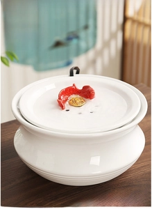 Close-up of ceramic desktop fountain with red koi fish and gold coin decorations