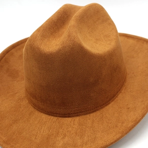 Macro view of brown suede texture and neat stitching on a wide-brim western cowboy hat