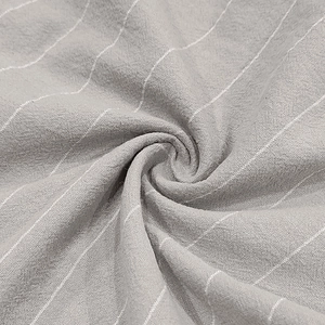 Macro shot of light gray striped linen fabric showing soft texture and weave detail