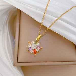 Luxurious gold flower necklace with multicolored gemstones on soft silk background