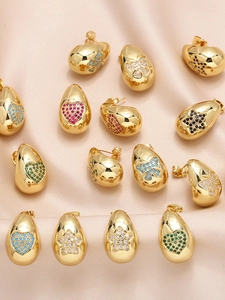 Detail view of gold-plated drop earrings with colorful zircon heart and butterfly patterns
