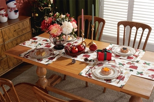 Detailed Christmas table runner and mats with red gift patterns in a cozy dining setting