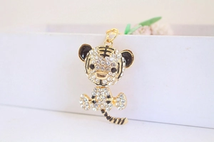 Detail of cute gold-toned tiger keychain with sparkling crystal rhinestones inlay