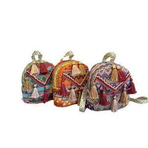 Ethnic woven backpack set with colorful fringe and patterns on white background