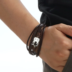 Men's brown multilayer braided leather bracelet featuring a silver owl charm and magnetic clasp